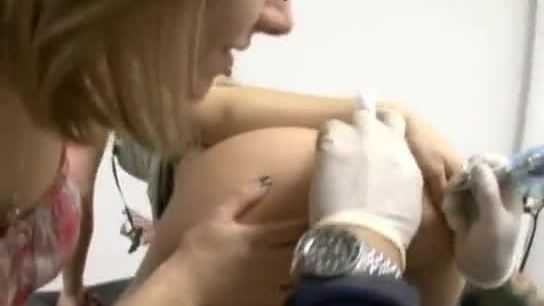 Ninety nine getting a new tattoo on her asshole